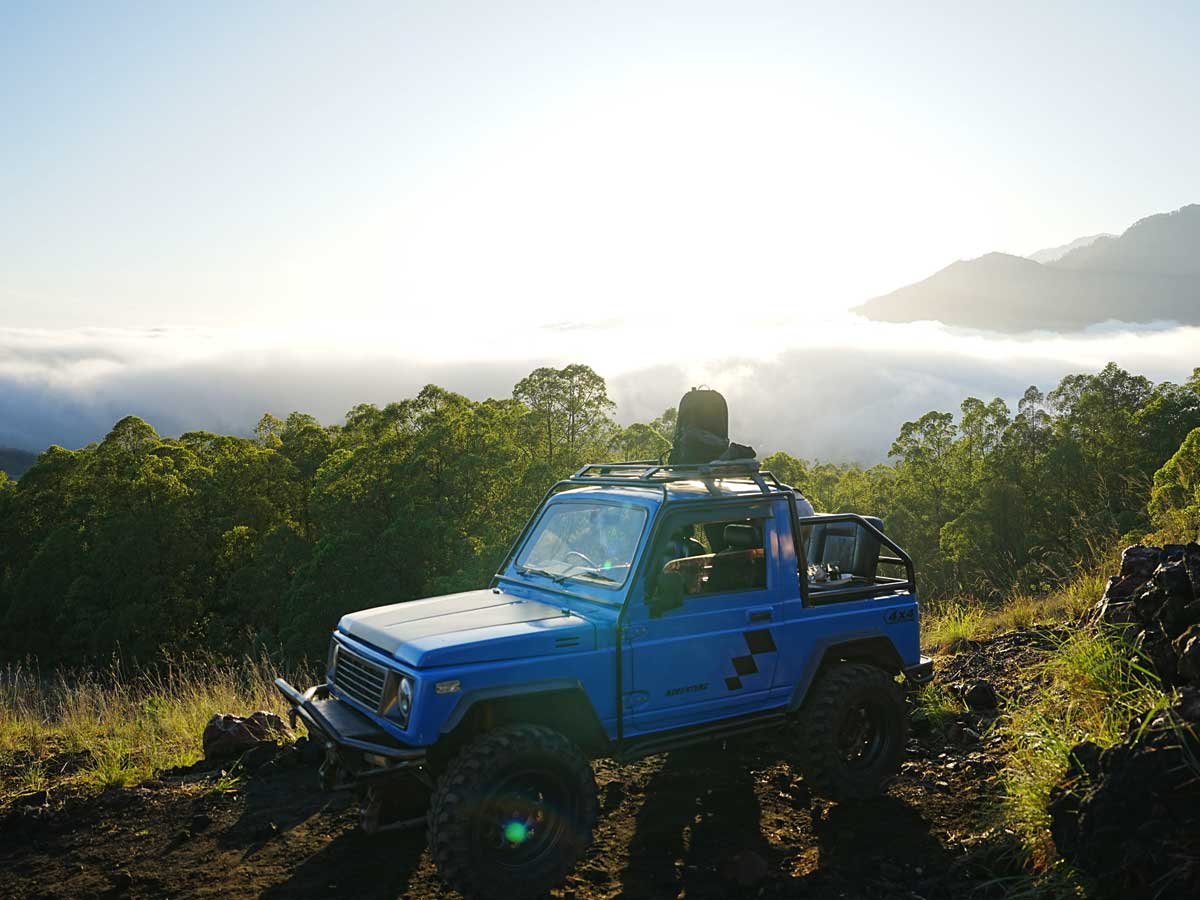 A 4x4 jeep at a Mount Batur viewpoint at sunrise
