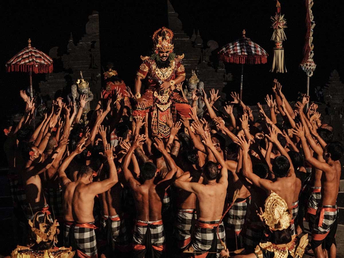 A circle of Kecak chanters performing at sunset