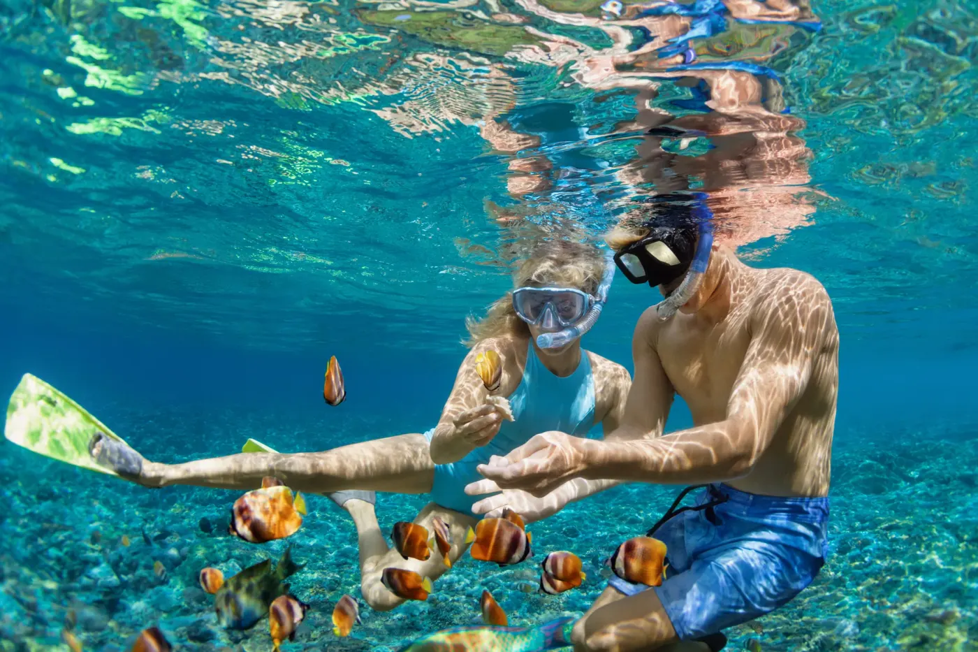 Children snorkelling over a shallow reef in east Bali